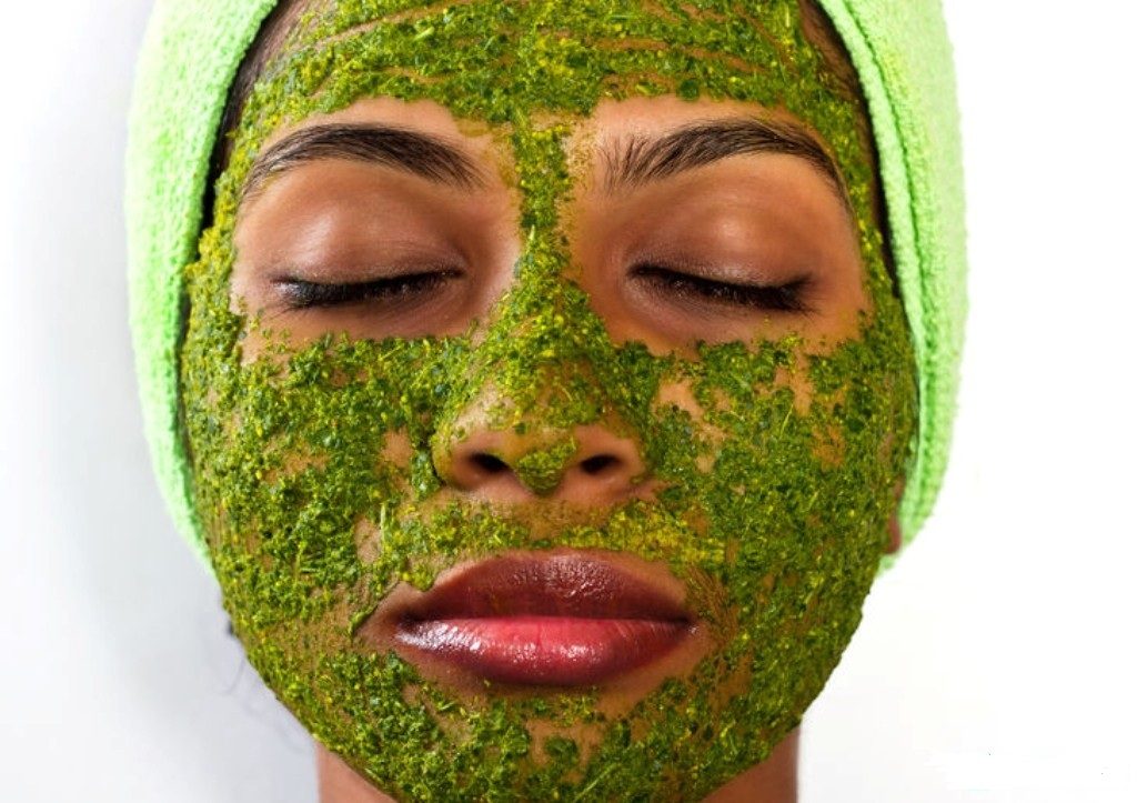 Girl with a cosmetic mask on her face