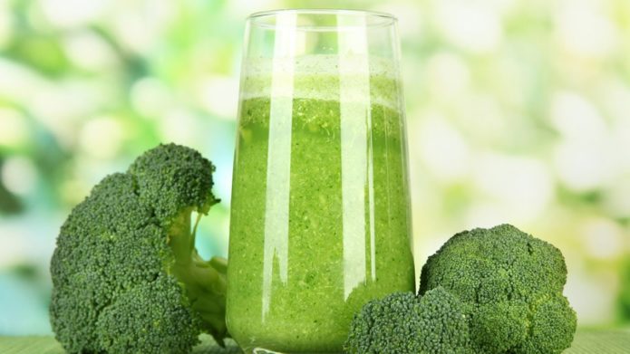 Broccoli inflorescences and squeezed juice in a glass