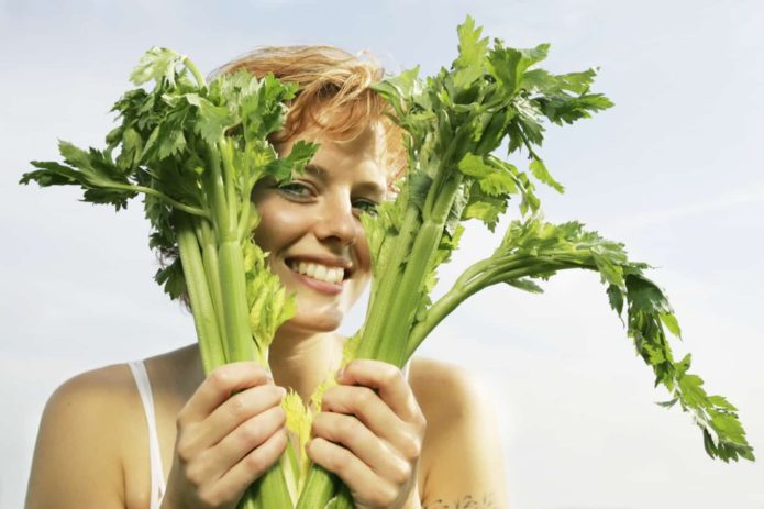 Woman holding celery