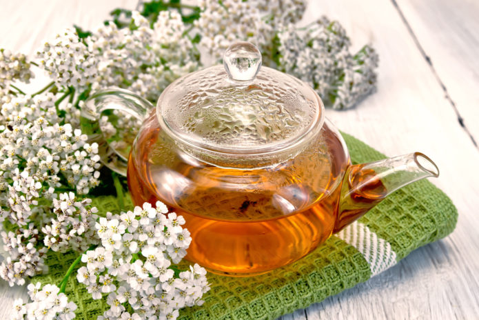 Tea looking for yarrow in a glass teapot